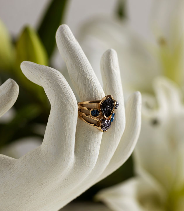 Close-up of a luxurious gold ring adorned with sparkling diamonds, showcasing exquisite craftsmanship and timeless elegance.